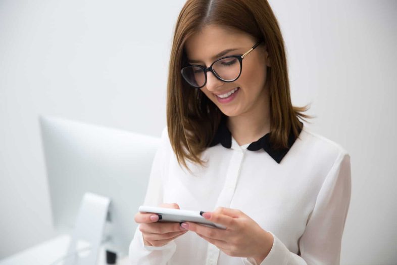 Portrait of beautiful businesswoman using smartphone